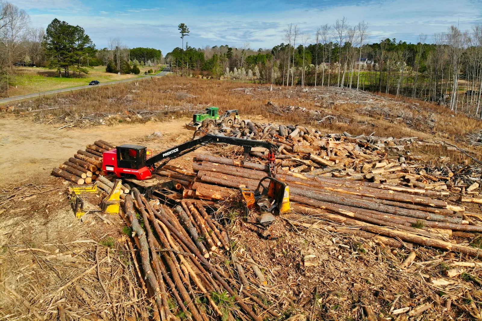 red and black heavy equipment on brown soil